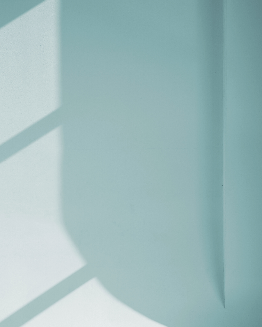 Light blue wall with geometric shadow patterns
