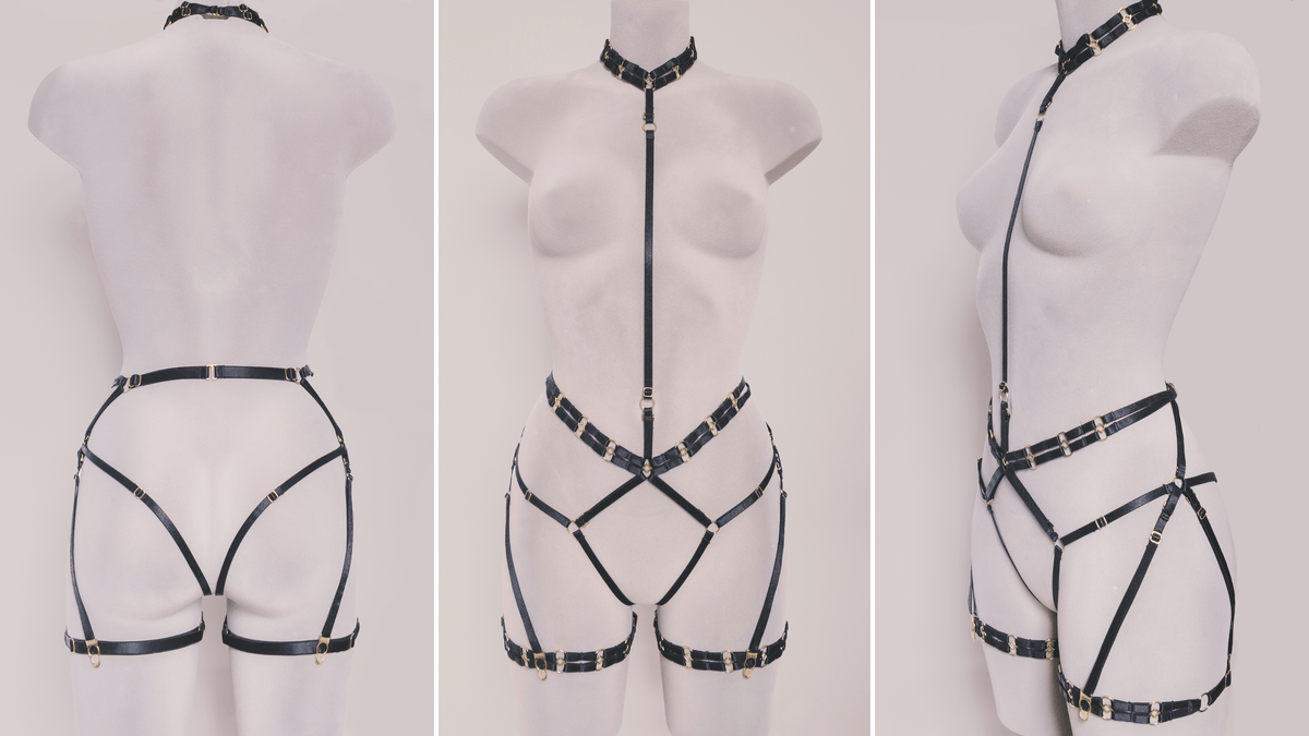 Three views of a black strappy harness-style lingerie or costume garment displayed on a white mannequin against a light neutral background. The mannequin is shown from the back, front, and side, highlighting the full coverage and fit of the harness.